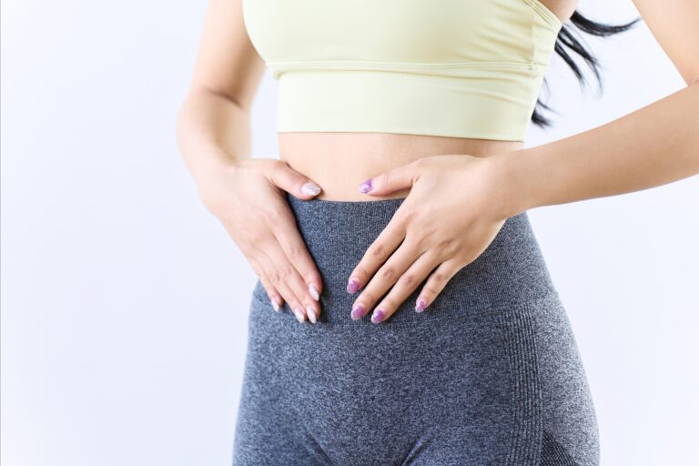 Woman holding her abdomen